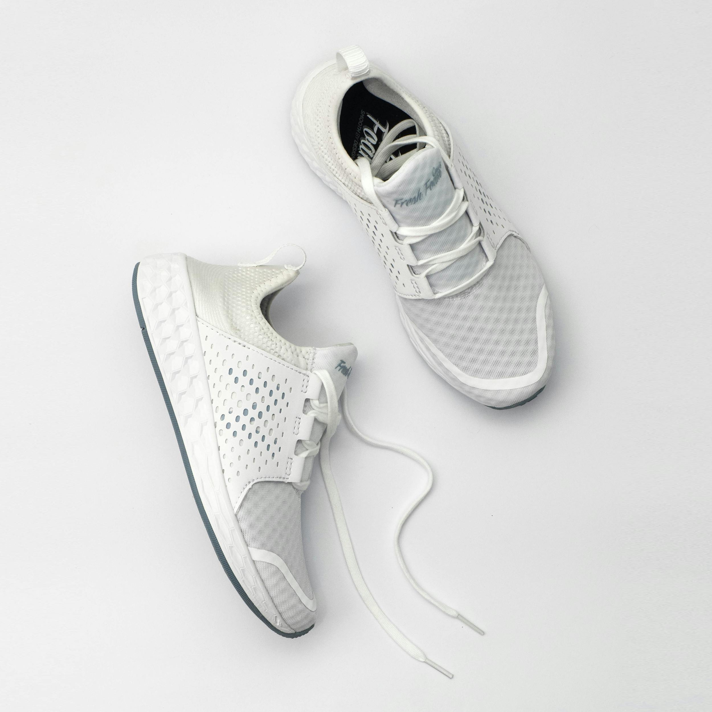 White athletic shoes on a light gray background